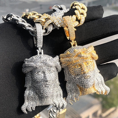 DatNewDrip iced out Jesus pendant duo in gold and silver with Cuban chain on black glove