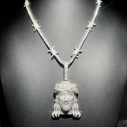 DatNewDrip iced out Jesus pendant diamond encrusted Jesus head with crown on sparkling stone chain displayed on black bust