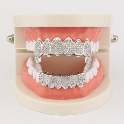 DatNewDrip iced out vampire fang grillz displayed on dental model silver cubic zirconia encrusted fangs