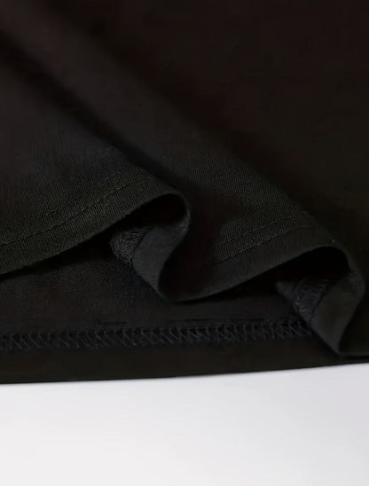 Close-up of the hem and stitching on a black praying hands t-shirt mens by DatNewDrip