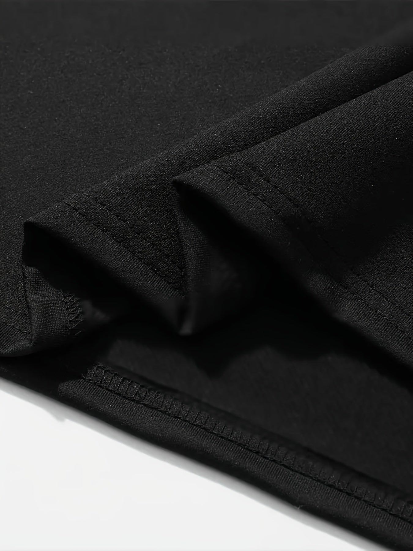 Close-up of the fabric and stitching of the Roots One Love t-shirt in black