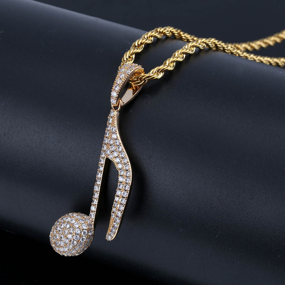 DatNewDrip iced out music note pendant in gold with pave crystals on rope chain for stylish streetwear