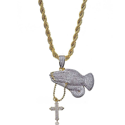 DatNewDrip iced out praying hands pendant on gold rope chain with dangling cross pave stones and two tone finish