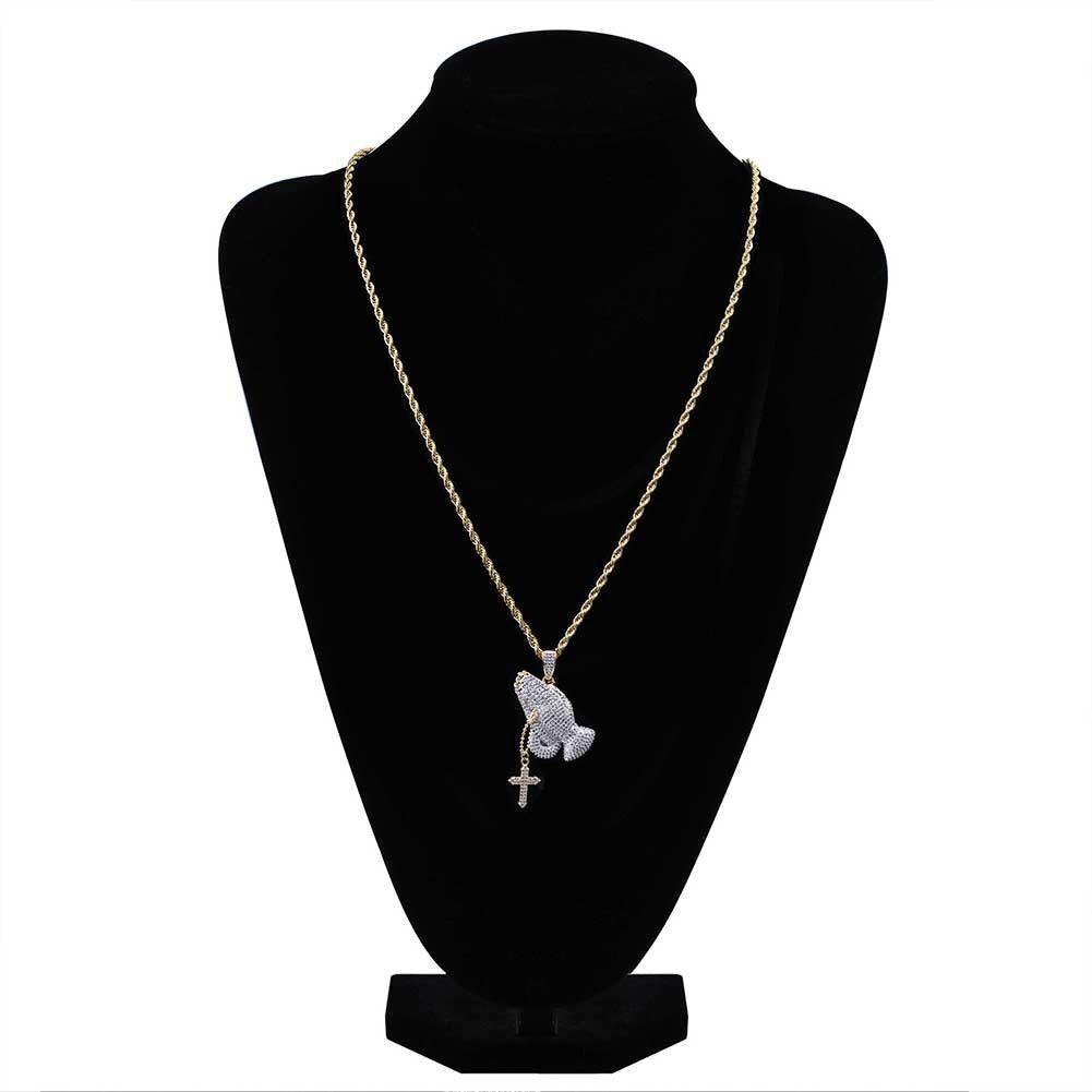 DatNewDrip iced out praying hands pendant on gold rope chain with small cross charm on black bust
