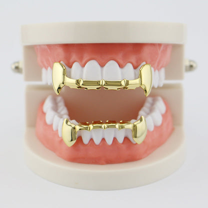 DatNewDrip gold fang grillz for teeth displayed on upper and lower dental model for costume wear