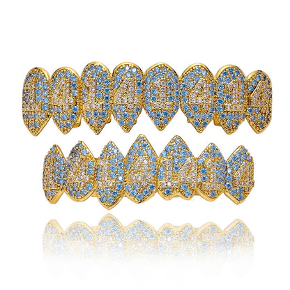 DatNewDrip iced out monster fang grillz in gold with blue and clear crystals full top and bottom set