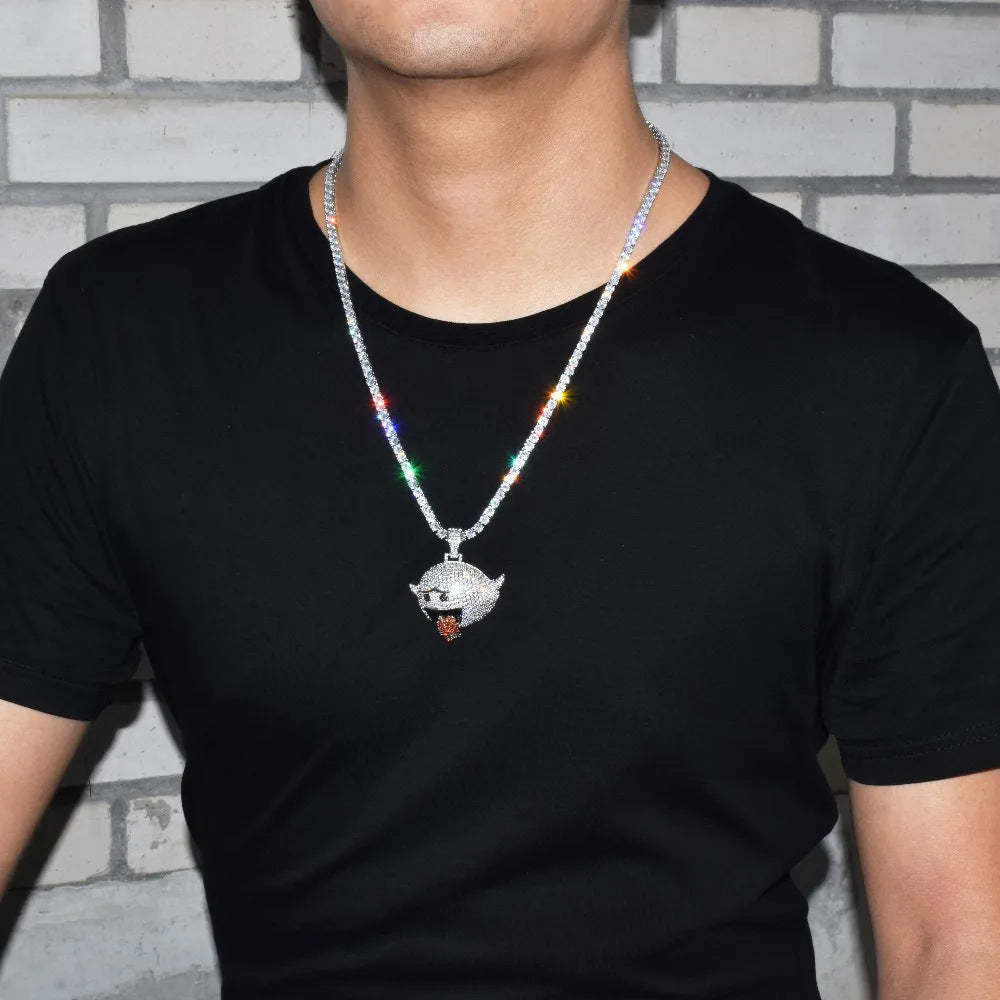 DatNewDrip Iced Out Naughty Ghost Pendant on silver Cuban chain worn on male model against brick background