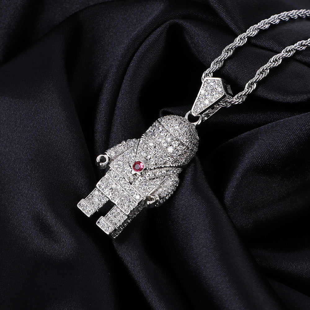 DatNewDrip iced out spaceman pendant in silver encrusted with CZ on rope chain with red gem chest accent