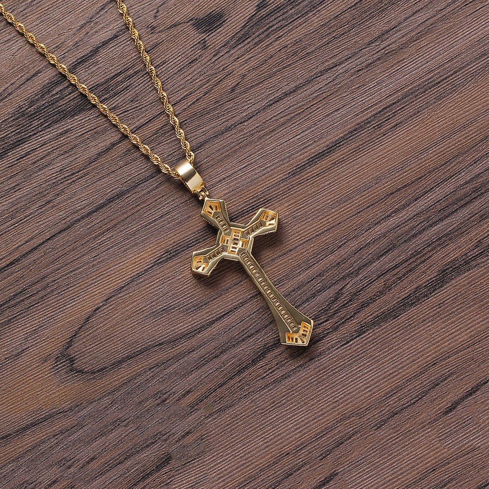 DatNewDrip gold chain with iced out cross pendant on wood background showcasing engraved details