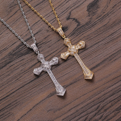 DatNewDrip iced out cross pendant pair in gold and silver with rope chains on wood background